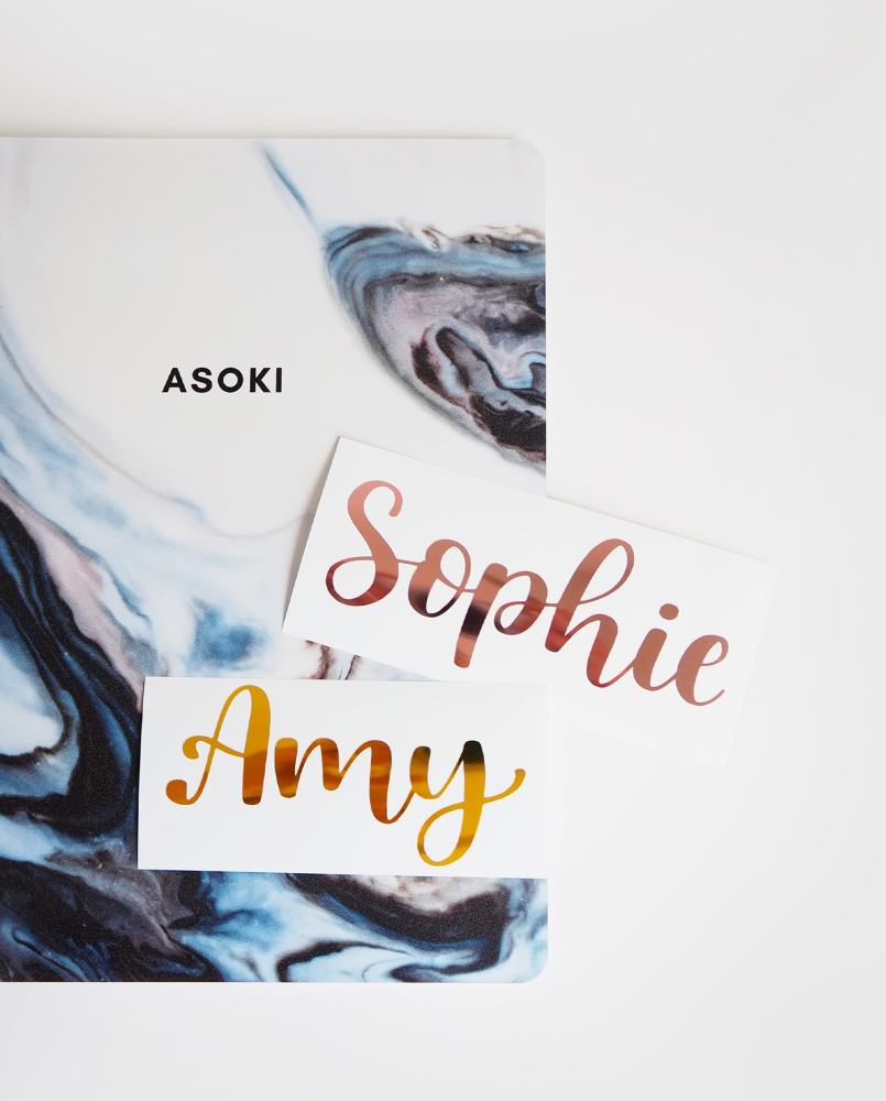 Marble-blue Asoki notebook with different custom calligraphy foil name stickers on top